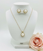 Pearl necklace and earrings on a clear stand with a rose in corner
