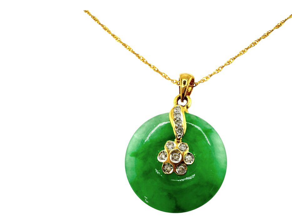 Green jade pendant with gold chain on a white background